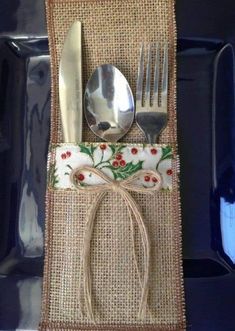 a fork, knife and spoon are sitting on a burlocked place mat