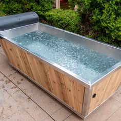 an outdoor hot tub in the middle of a patio