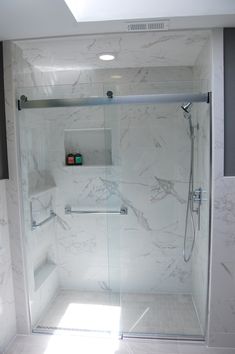 a walk in shower sitting inside of a bathroom