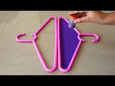 someone is painting the shape of a pink and purple object