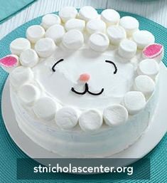 a cake decorated with marshmallows and a sheep face