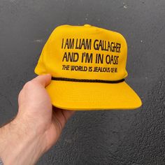 Ready to ship Do you like Wonderwall? Are you an icon? If not, this amazing yellow Oasis hat will make you one. The Snapback allows you to adjust the hat size to fit many different people comfortbly. Different People, Liam Gallagher, Embroidered Cap, Black Rope, Embroidered Caps, Hat Sizes, Caps Hats, Oasis, Make It Yourself