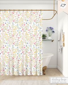 a shower curtain with flowers on it in a white and blue bathroom setting, next to a bathtub