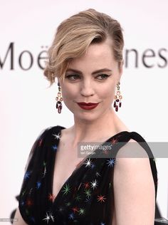 the actress is posing on the red carpet at the amfar awards ceremony in los