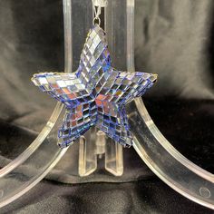 a glass ornament with a star on it