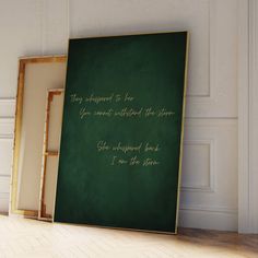 there is a green chalkboard with gold writing on it in front of a white wall