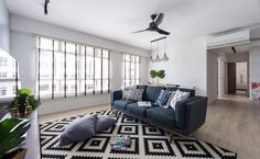 a living room filled with furniture and lots of windows next to a wall mounted air conditioner