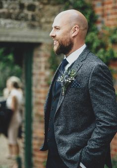 a man in a suit and tie standing outside