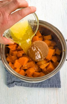 a person is spooning sugar into a bowl of sweet potatoes