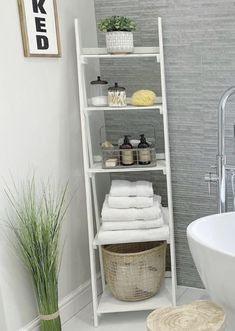 a bathroom with a white shelving unit next to a bathtub