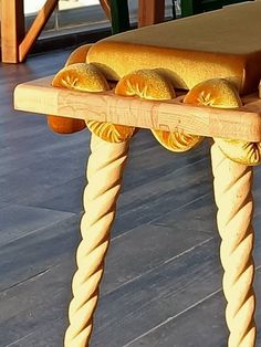 a wooden table with four buns on it and some bread in the middle sitting on top of it