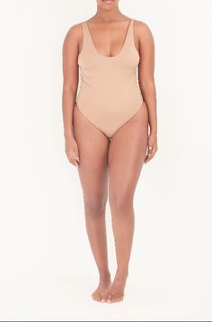 Look good, feel great in the Bonita Bodysuit! This comfortable and sleek one-piece is the perfect pick for styling up your summer swimming, beach, or pool days. It's supportive and stylish, giving you all the confidence you need to take on the waves - or the heat! Model is 5'3 and wearing a size small Fitted Backless Swimwear With Built-in Bra, Solid Swimwear With Built-in Bra, One-piece Swimwear With Built-in Bra And Stretch, Contoured Swimwear With Built-in Bra For Poolside, Seamless Bodysuit For Sunbathing, Backless Swimwear For The Beach, Seamless One-piece Beachwear Bodysuit, Seamless Beachwear Bodysuit For Sunbathing, Smoothing Underwire Swimwear For Beach