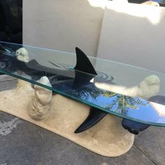 a glass table with two sharks on it