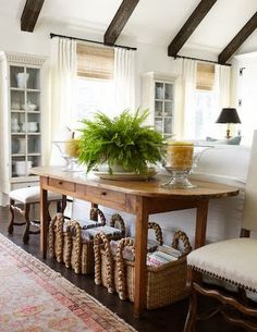 a dining room table with chairs and a potted plant sitting on top of it