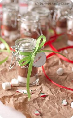 a jar filled with white and green candy sitting on top of a piece of paper