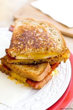 a grilled cheese sandwich sitting on top of a white plate