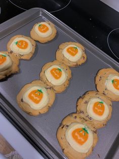 six cookies with an egg in the middle on a baking sheet, ready to go into the oven