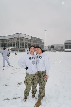 two people are standing in the snow together