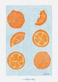 an orange cut in half on top of a blue paper with watercolors and ink