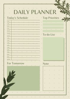 a daily planner with green leaves on the top and bottom page, in front of it