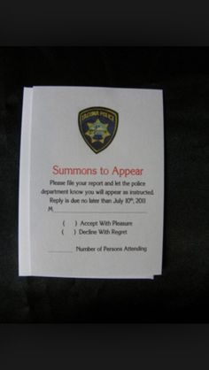 a police badge is on top of a piece of paper that says, summons to appear