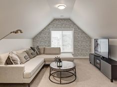 a living room filled with furniture and a flat screen tv