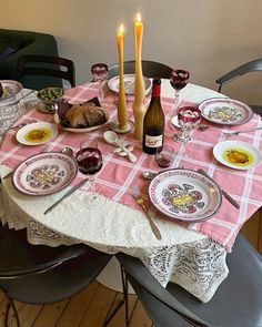 a table set with plates and wine glasses