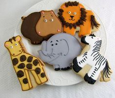 a plate with cookies decorated like animals and giraffes