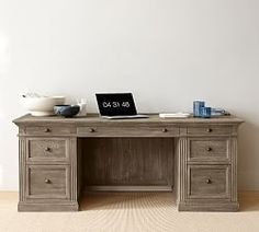 an old wooden desk with a laptop on it