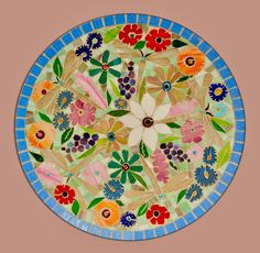 a colorful plate with flowers and leaves painted on it