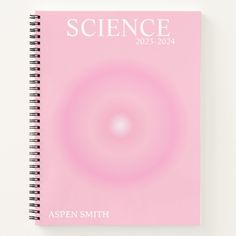 a pink spiral notebook with the words science written in white on it and an image of a