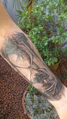 a man's arm with an image of a woman and trees on the side