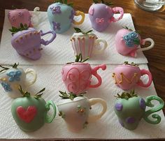 there are many different shaped tea cups on the table