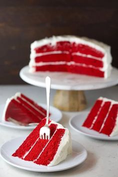 a slice of red velvet cake with white icing