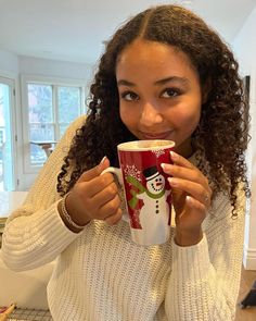 a woman holding a coffee cup in her hands