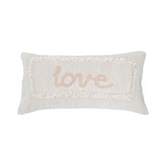 a white pillow with the word love on it and fringe trimming around the edges