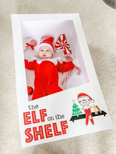 the elf on the shelf book is open to show an image of a baby in a santa hat