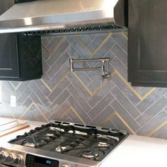 a stove top oven sitting inside of a kitchen next to black cabinets and counter tops