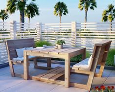 a wooden table sitting on top of a patio next to a white fence and palm trees