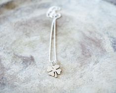 This dainty four-leaf clover charm is sure to bring luck to anyone that wears it! This good luck clover necklace is made of 925 sterling silver. Clover necklace measure: 15.6 in. + 2,4 in extension chain Clover pendant size: 12 x 12.5 mm You can choose the chain: - Ball chain - Rolo chain This necklace is available in: - Gold plated: https://www.etsy.com/listing/675773043/four-leaf-clover-necklace-dainty-gold - Rose gold plated: https://www.etsy.com/listing/744222797/dainty-four-leaf-clover-neck Good Luck Sterling Silver Necklace With Delicate Chain, Dainty Flower Pendant Jewelry For Good Luck, Dainty Good Luck Jewelry With Flower Pendant, Delicate Silver Jewelry For Best Friend, Dainty Flower Pendant Charm Necklace For Good Luck, Silver Necklaces With Flower Charm For Good Luck, Silver Necklace With Flower Charm For Good Luck, Dainty Good Luck Flower Pendant Charm Necklace, Minimalist Sterling Silver Jewelry For Good Luck