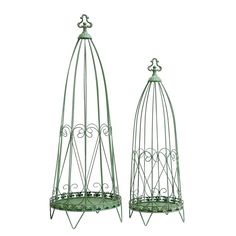 two green metal bird cages sitting next to each other