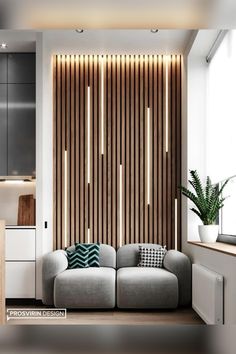 a modern living room with wood slats on the wall and grey couch in front