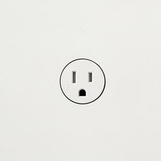 a white electrical outlet with two black outlets