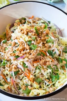 a white bowl filled with coleslaw and nuts