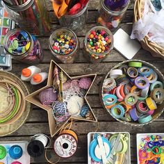 various craft supplies are laid out on a wooden table