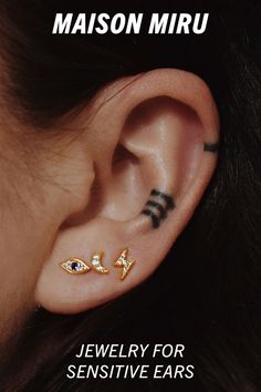 an ear with two different piercings on it and the words, maison miru jewelry