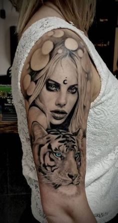 a woman with a tiger tattoo on her arm