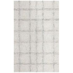 a white and grey rug with small squares on the bottom, in an irregular pattern