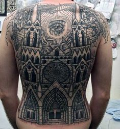 the back of a man's body with an all seeing eye tattoo on it