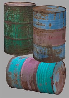 three old tin canisters are stacked on top of each other, one is green and the other is blue